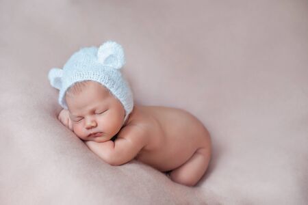 Ten days old newborn baby girl sleeping on a pink blanket.の写真素材