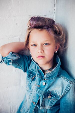 Fashion portrait of 8 years old russian girl with colored lilac hair.