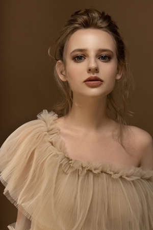 Beauty portrait of young caucasian model. Trendy fashion shot in golden tones.の写真素材