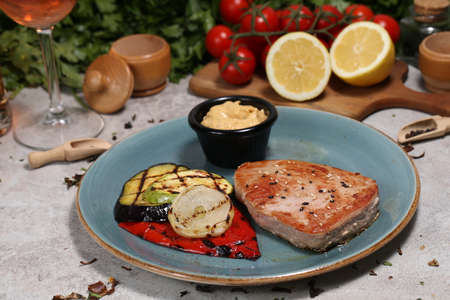 Salmon steak with roasted vegetables and spinach salad. Delicious, nutritious eating.の写真素材