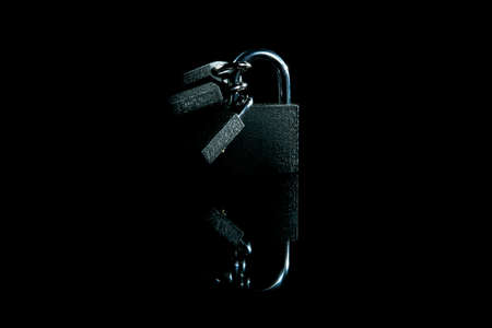 silver padlock on black background close up