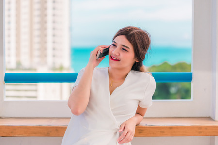 Woman was video call with his friend over the phone, On a wonderful holidayの写真素材
