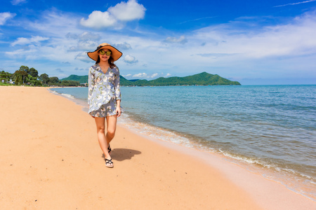 Woman traveler is enjoying the beautiful sea view on her holiday.の写真素材