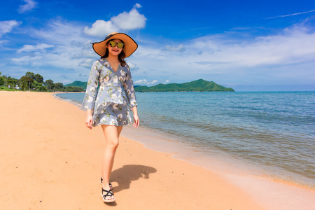 Woman traveler is enjoying the beautiful sea view on her holiday.の写真素材