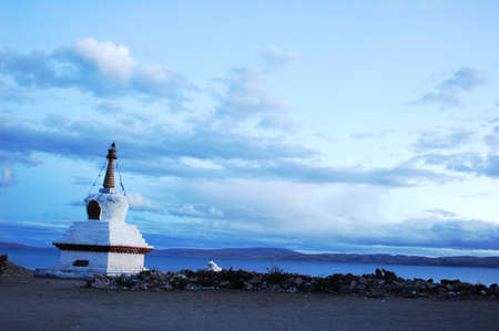 Landscape of a white stupa by a lake in Tibetの写真素材