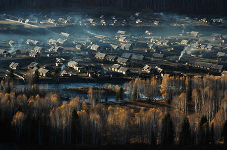 Landscape of a small village and woods in an autumn morningの写真素材