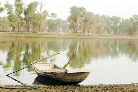 Scenery of a wooden boat at a lakeの写真素材