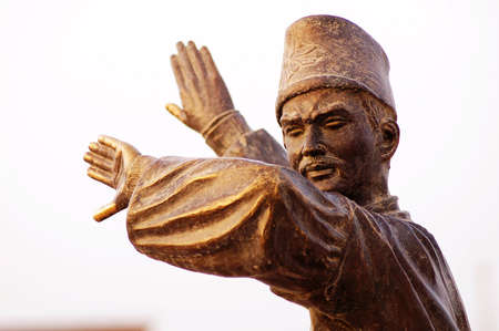 Statue of a male dancer on white backgroundの写真素材