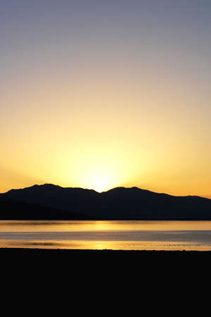 Landscape of mountains and lake at sunriseの写真素材