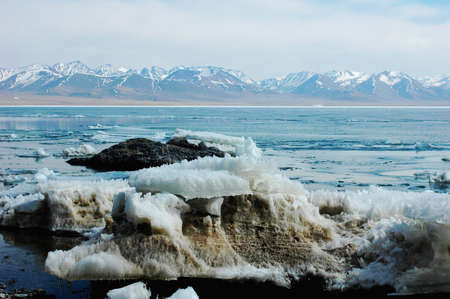 Scenery of a frozen lake and mountains in Tibetの写真素材