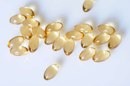 Macro of a bunch of yellow gel pills. の写真素材