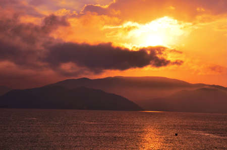 Landscape of golden sunrise at a seashoreの写真素材