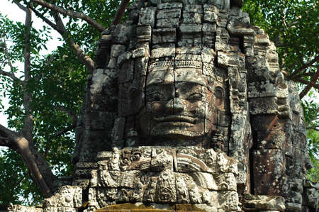 Giant ancient buddha rock statue at Angkor Cambodiaの写真素材