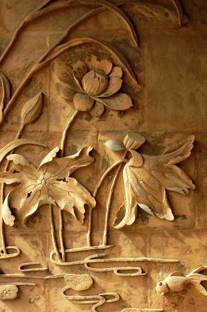 Ancient brick carving art of lotus flowersの写真素材