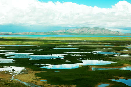 Landscape of lakes and skies with white cloudsの写真素材