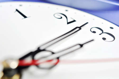 Closeup view of hour,minute and second hands of a wall clock, shallow DOF