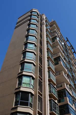 New high residential apartment block against blue sky