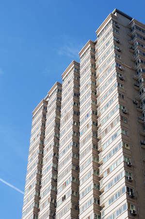 Bottom view of modern apartment buildings against blue skyのeditorial素材