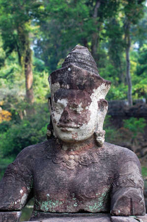 Giant ancient buddha rock statue at Angkor Cambodia