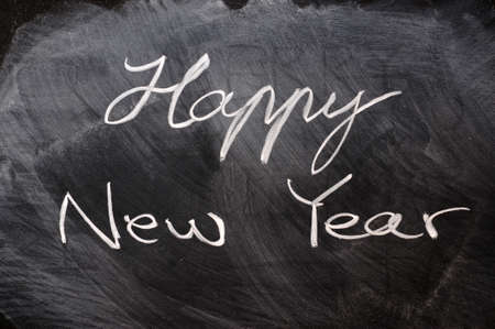 Handwriting of Happy New Year on a blackboardの写真素材
