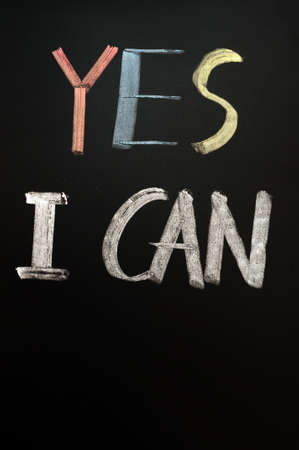 Chalk handwriting of "Yes I Can" on a blackboardの写真素材