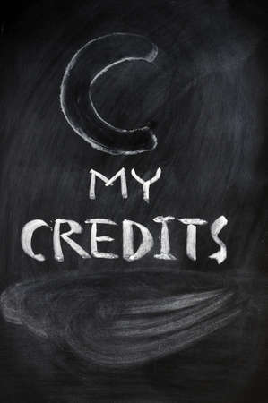 Credits sign written with chalk on a blackboard