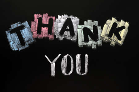 Thank you - text written with colorful chalk on blackboardの写真素材