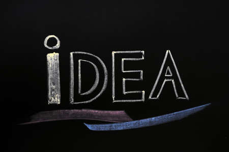 Idea written with chalk on blackboardの写真素材