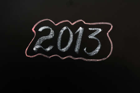 Year 2013 written with chalk on a smudged blackboardの写真素材