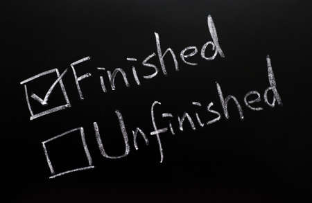 Finished and unfinished check boxes on a blackboardの写真素材