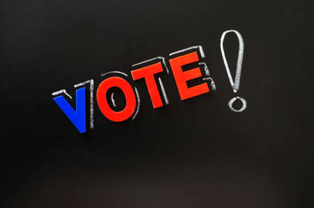 Vote with a big exclamation mark on a blackboardの写真素材