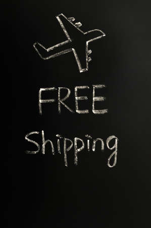 Free shipping concept written in chalk on a blackboardの写真素材