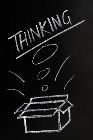 Thinking outside the box concept drawn on a blackboardの写真素材