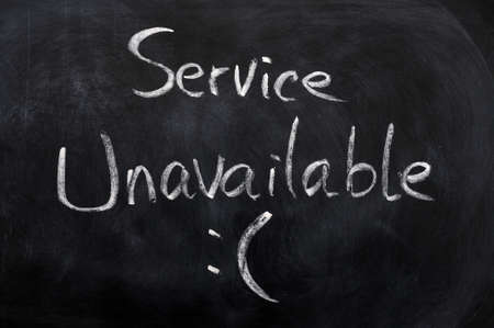 Service unavailable written on a blackboard backgroundの写真素材