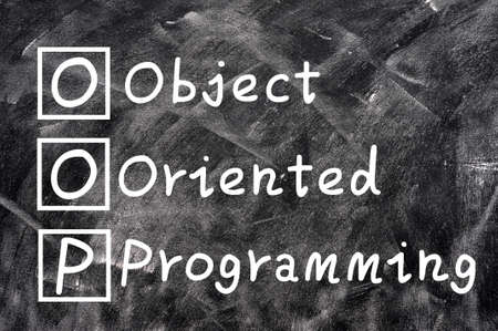 Chalk writing of OOP for Object Oriented Programming on a blackboard