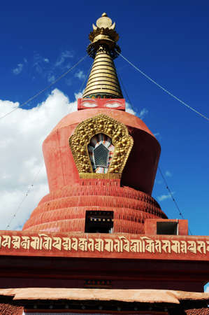 Historic red stupa in Tibet, against blue sky