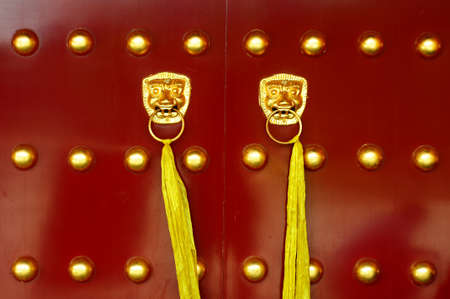 Traditional Chinese ancient red door with golden doorknobsの写真素材