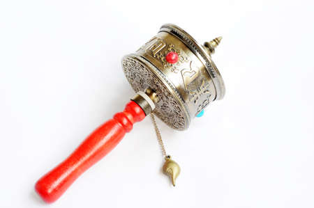 Copper Tibetan prayer wheel on a white background,used as buddhist instrument or souvenir  