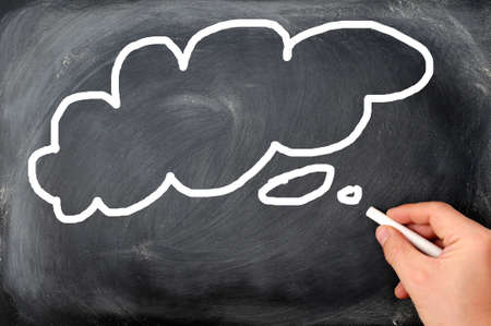 Thought bubble drawing with chalk on black chalkboard  Copy space for text  Nice background texture の写真素材