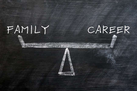 Balance of family and career - concept drawn with chalk on a smudged blackboardの写真素材