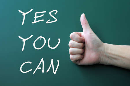Yes you can - written with chalk on a blackboard background,with thumbs up gestureの写真素材