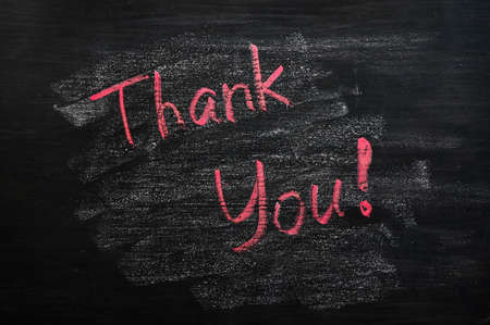 Thank you written with red chalk on a smudged blackboard