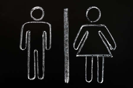 Men and women symbols drawn on a blackboard backgroundの写真素材