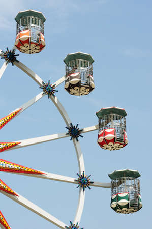 Bottom up view of Ferris wheel against blue sky in a parkの写真素材