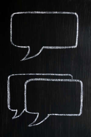 Chalk drawing of speech bubbles on a blackboard