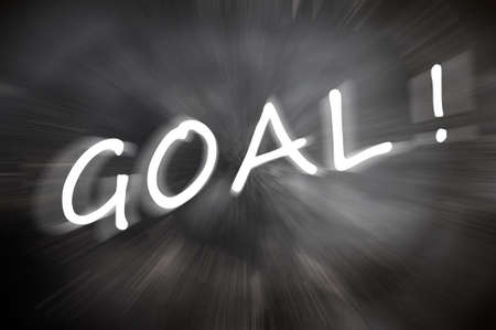 Chalk drawing of  Goal  word written on a blurred chalkboard with motion raysの写真素材