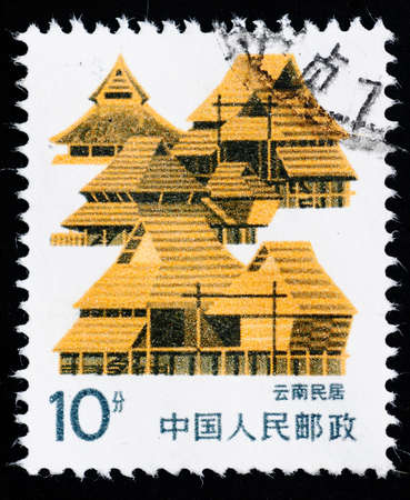 A Stamp printed in China shows the traditional dwelling in Yunnan, 1998のeditorial素材