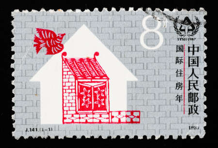A stamp printed in China shows International Year of shelter, circa 1987のeditorial素材