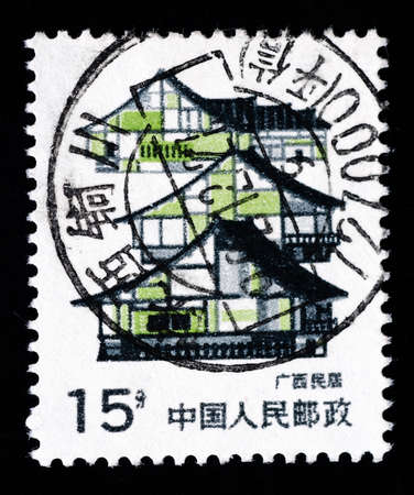 A Stamp printed in China shows local dwelling in Guangxiのeditorial素材