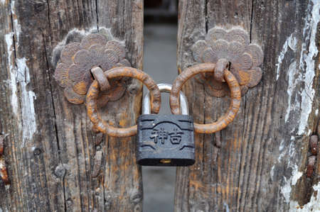Iron doorknob or knockers on an old gateの写真素材